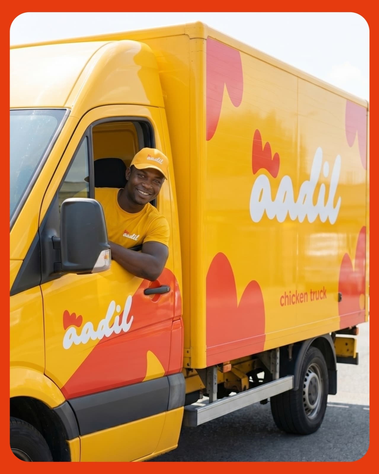 Yellow delivery truck in full Aadil livery with the driver leaning out